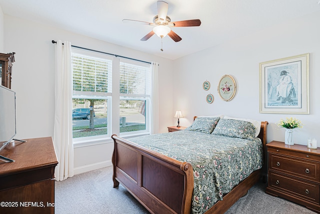 bedroom featuring baseboards, ceiling fan, and light colored carpet