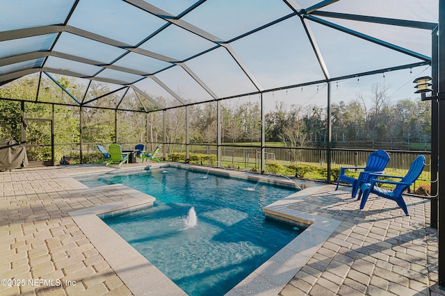 view of swimming pool with a fenced in pool, glass enclosure, a patio area, and fence