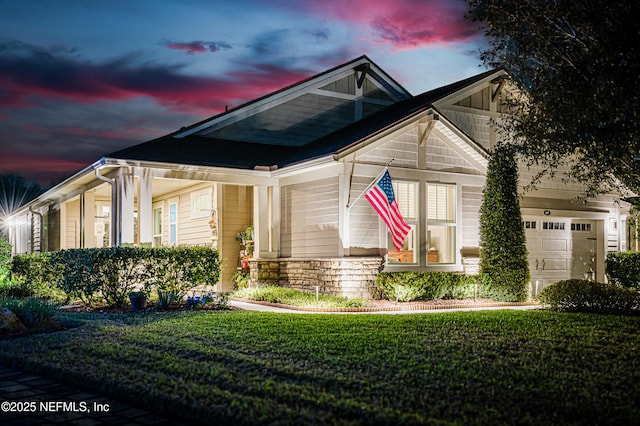 craftsman-style home featuring a garage and a front yard