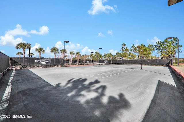 view of tennis court with fence