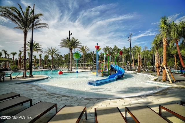 community playground featuring a water play area and a community pool