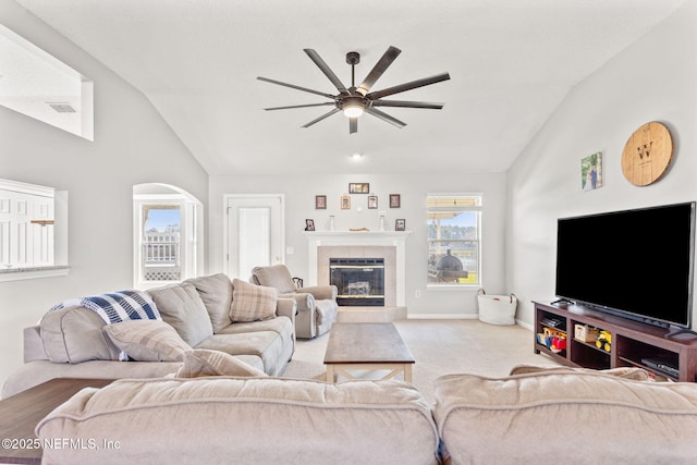 living room featuring ceiling fan, a fireplace, visible vents, baseboards, and carpet