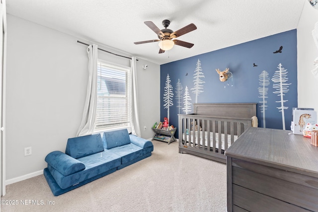 bedroom featuring a ceiling fan, carpet flooring, and a textured ceiling