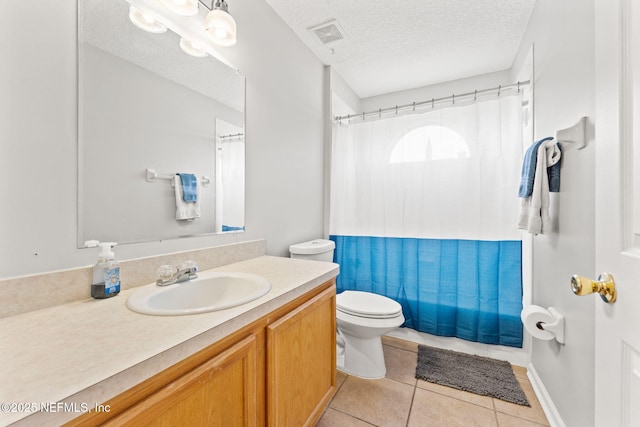 bathroom featuring a textured ceiling, tile patterned flooring, toilet, vanity, and visible vents