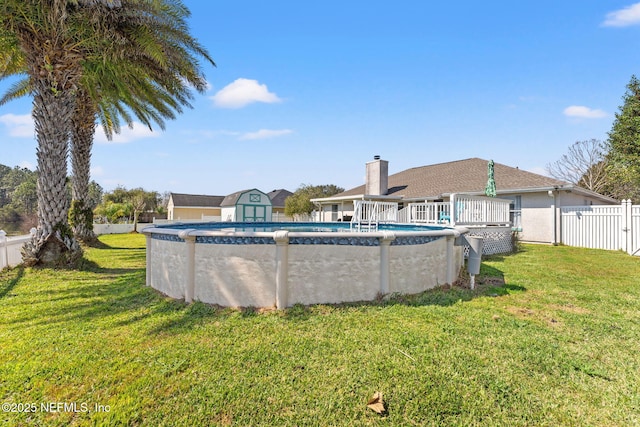 view of pool featuring a fenced in pool, a yard, a storage unit, and fence