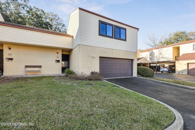 view of property featuring a garage, driveway, a front lawn, and stucco siding