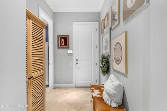 interior space featuring crown molding and baseboards