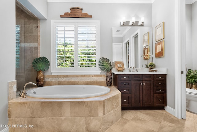 full bath featuring a garden tub, crown molding, vanity, and toilet