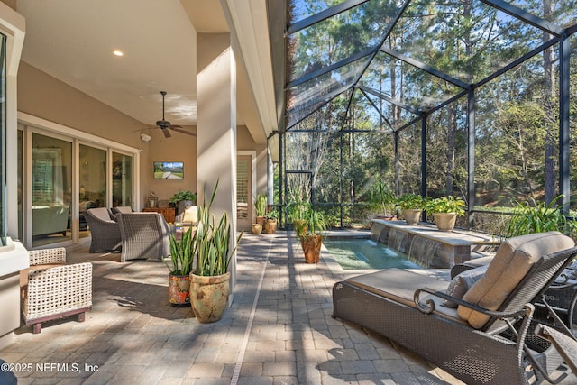 view of patio / terrace with a lanai, ceiling fan, and an outdoor living space