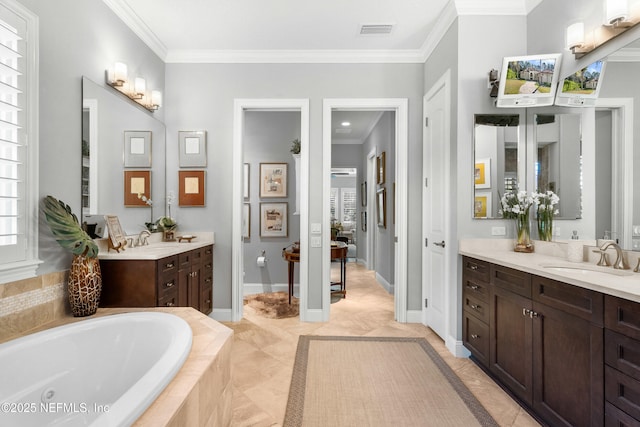 full bath featuring visible vents, ornamental molding, a sink, a jetted tub, and baseboards