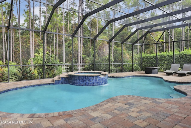 view of swimming pool with a lanai, a patio area, and a pool with connected hot tub