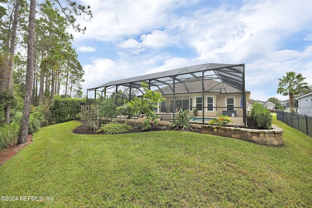 view of yard featuring a lanai and fence