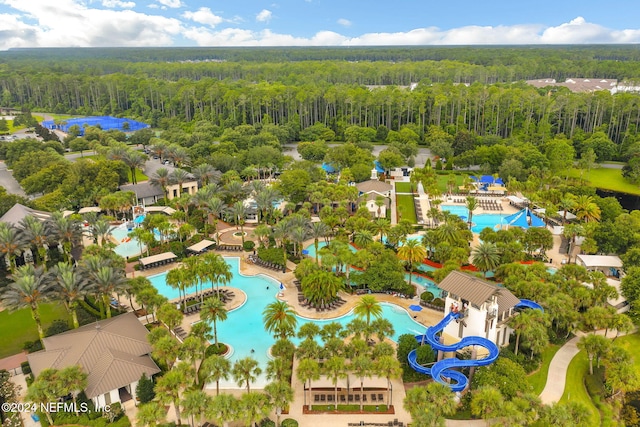 birds eye view of property featuring a wooded view