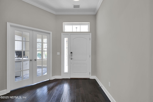 entrance foyer with crown molding, french doors, dark wood-type flooring, and baseboards