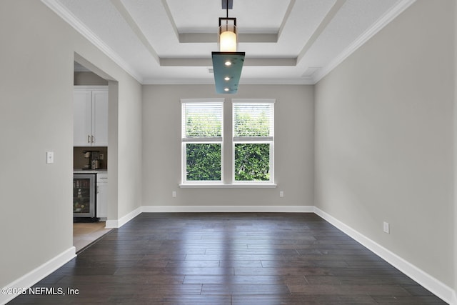 unfurnished living room featuring dark wood-type flooring, wine cooler, a raised ceiling, and baseboards