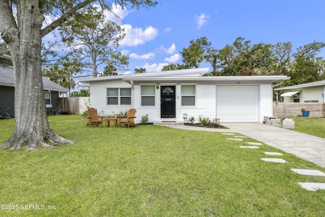 view of front of house featuring driveway, a garage, fence, and a front lawn
