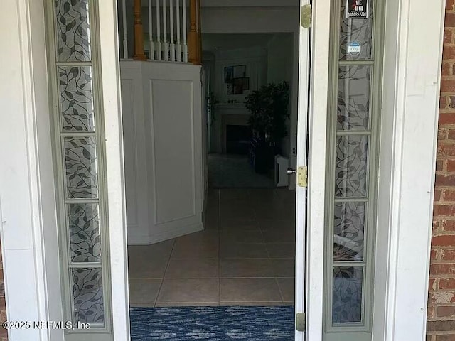 corridor with brick wall and tile patterned floors