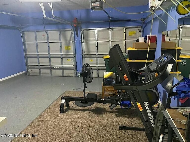 garage with baseboards and a garage door opener