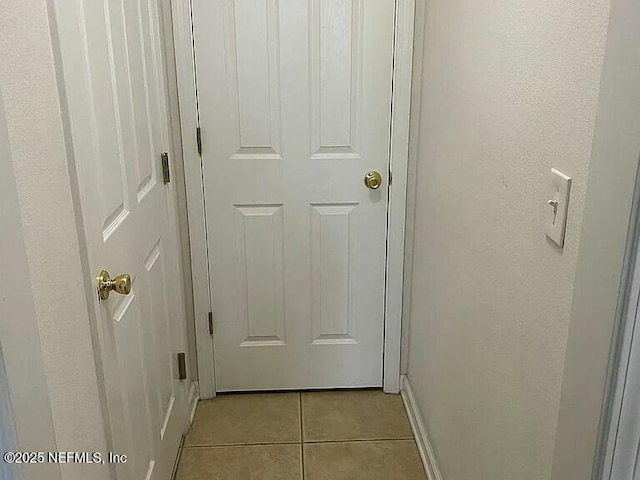 entryway with light tile patterned flooring