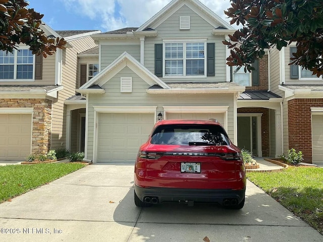 view of property with a garage and concrete driveway