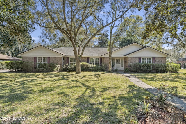 ranch-style home featuring a front yard and brick siding