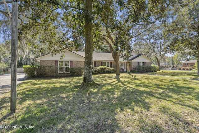 ranch-style home with brick siding and a front lawn