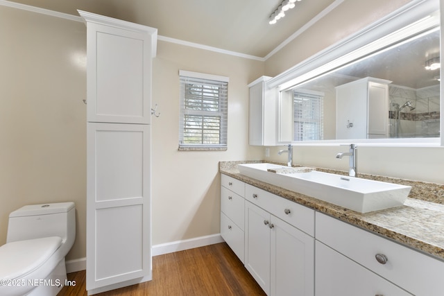 full bathroom featuring toilet, a tile shower, a sink, and wood finished floors