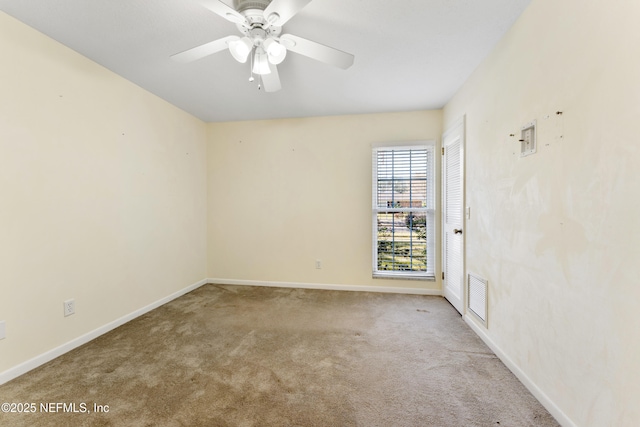 unfurnished room with a ceiling fan, carpet, visible vents, and baseboards