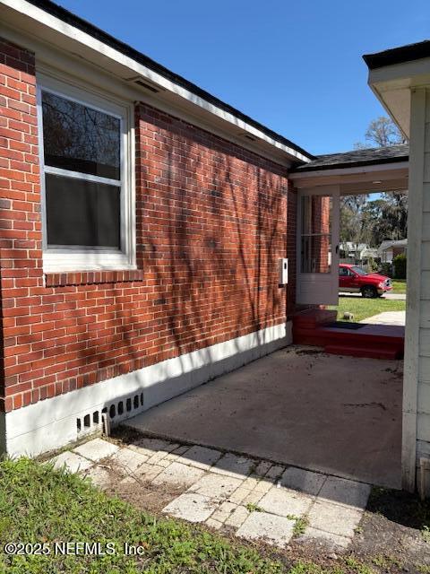 view of home's exterior with brick siding