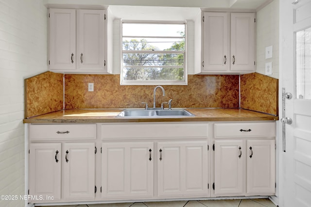 4804 Elizabeth Ter, Jacksonville, FL 32205 - kitchen featuring white cabinets, light countertops, and a sink