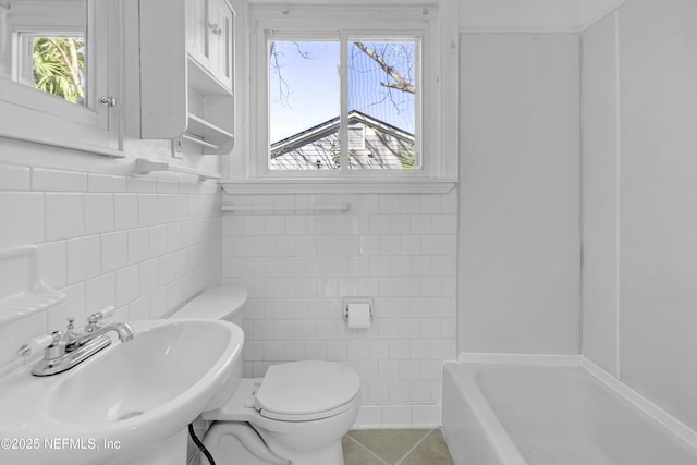 4804 Elizabeth Ter, Jacksonville, FL 32205 - full bath with a tub to relax in, toilet, a sink, tile walls, and tile patterned floors