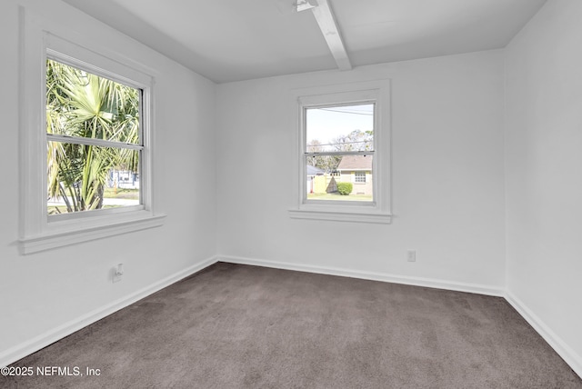 4804 Elizabeth Ter, Jacksonville, FL 32205 - empty room featuring beamed ceiling, dark carpet, and baseboards