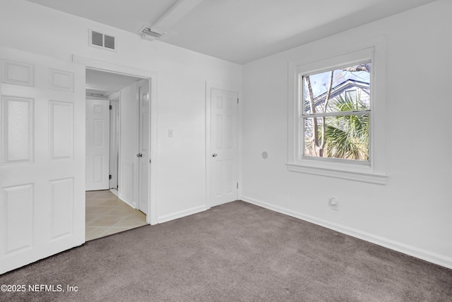 4804 Elizabeth Ter, Jacksonville, FL 32205 - unfurnished bedroom featuring tile patterned flooring, carpet flooring, visible vents, and baseboards