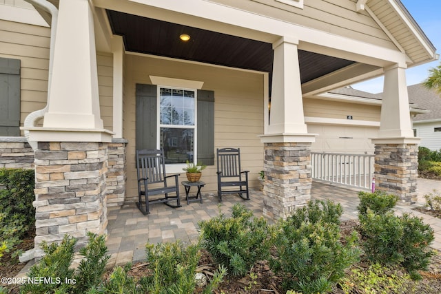 view of patio with a garage and covered porch