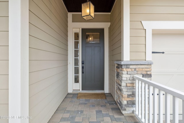 entrance to property featuring stone siding