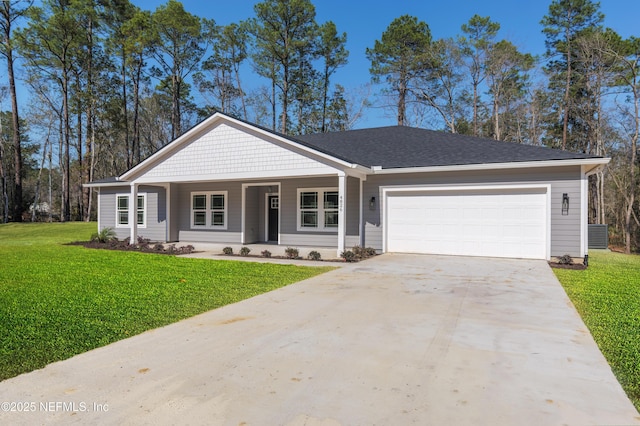 view of front of property with a front yard, covered porch, driveway, and an attached garage