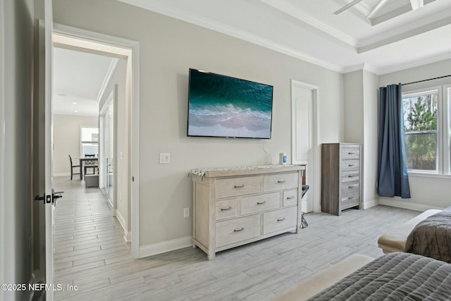 bedroom featuring baseboards, light wood-style flooring, and crown molding