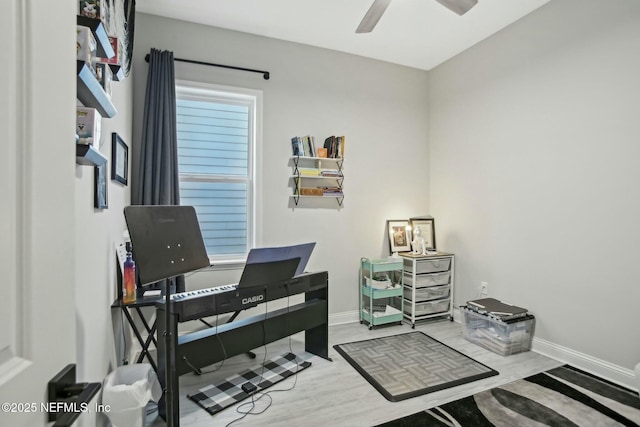 office area featuring ceiling fan, wood finished floors, and baseboards