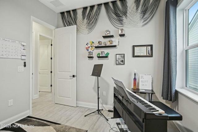 interior space with light wood-style floors, visible vents, and baseboards