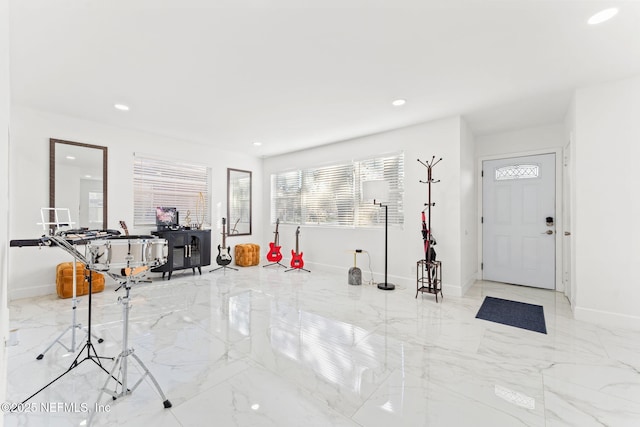 foyer entrance with marble finish floor, baseboards, and recessed lighting