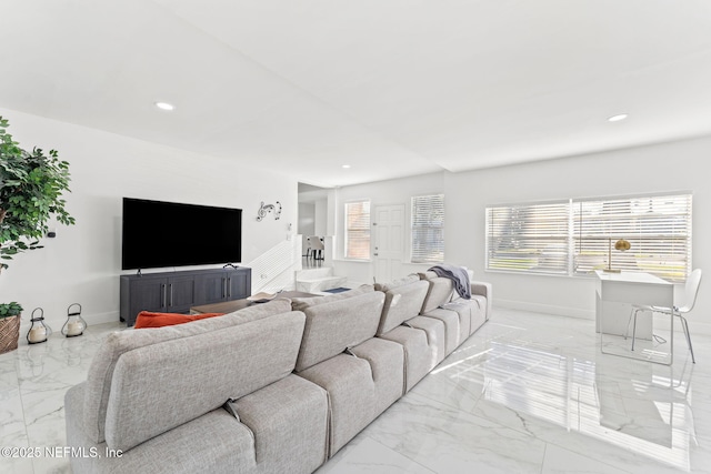 living area with a healthy amount of sunlight, marble finish floor, baseboards, and recessed lighting