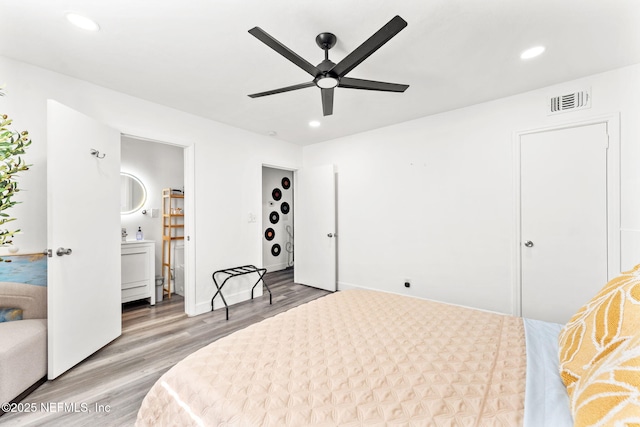 bedroom featuring visible vents, ensuite bathroom, wood finished floors, and recessed lighting