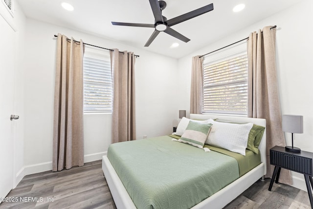 bedroom featuring a ceiling fan, recessed lighting, baseboards, and wood finished floors