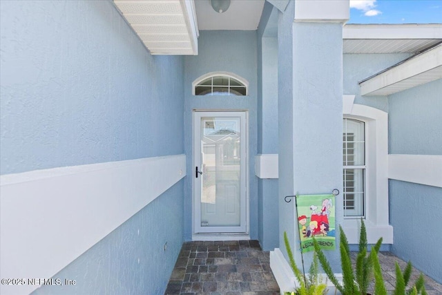 doorway to property with stucco siding