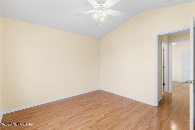 unfurnished room featuring lofted ceiling, baseboards, a ceiling fan, and light wood-style floors