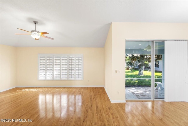 unfurnished living room featuring vaulted ceiling, ceiling fan, baseboards, and wood finished floors