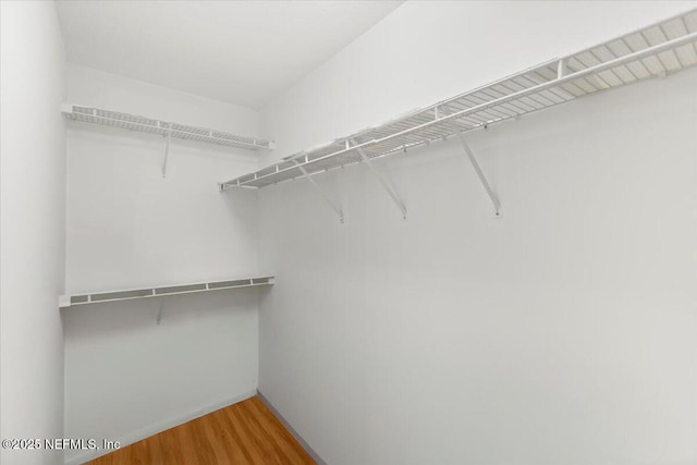 spacious closet with wood finished floors