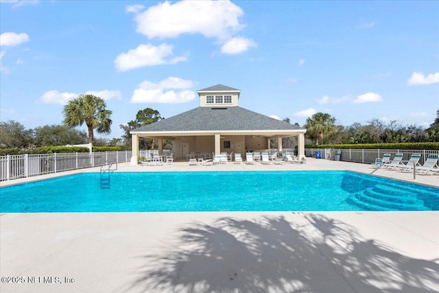 pool featuring a patio area and fence