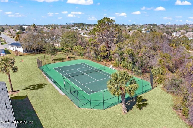 view of sport court featuring fence and a yard