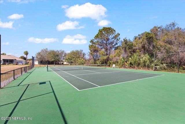 view of tennis court featuring fence